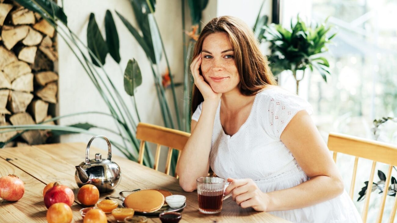 6 Ways to Reduce Food Noise Naturally: Quiet Your Mind Without GLP-1s- a woman smiling around food